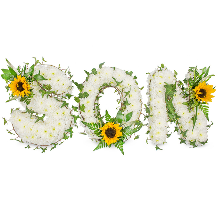 A striking, three-dimensional funeral tribute that spells the word son in bold capital letters, each letter meticulously formed from a dense mass of pristine white chrysanthemums. The chrysanthemums' clustered blooms produce a pillowy, tactile surface that appears soft under the cool, even studio illumination, revealing delicate petal edges and subtle internal shadows. Winding through the white florals are trails of deep green ivy with characteristic lobed leaves, their glossy texture and curling stems lending a sense of continuity and living connection across the piece. Complementary lighter greens - feathery fern fronds and slender pointed leaves - are artfully layered into the letter bowls and junctions to provide relief and botanical contrast against the chrysanthemums' uniform white. Three vivid sunflowers offer warm visual anchors: a cheerful sunflower crowns the upper-left curve of the S, another rests low within the O's circumference cradled by ferns, and a third punctuates the upper-right angle of the N. The sunflowers' golden-yellow petals and dark brown centers introduce a hopeful, sunlit note to the otherwise tranquil white-and-green palette. Photographed on a stark white backdrop, the arrangement's contours and textures are high in contrast and clarity, making it clearly legible for viewing or memorial service displays. This bespoke tribute reads as both an emblem of mourning and a celebration of memory - a composed, heartfelt option for those arranging a funeral for a son in Collier Row, Romford or the wider Havering area, where families often seek floral designs that marry quiet dignity with a gentle optimism.